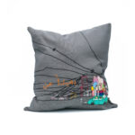 A square gray linen cushion cover featuring a colorful hand-embroidered scene of a car and city.