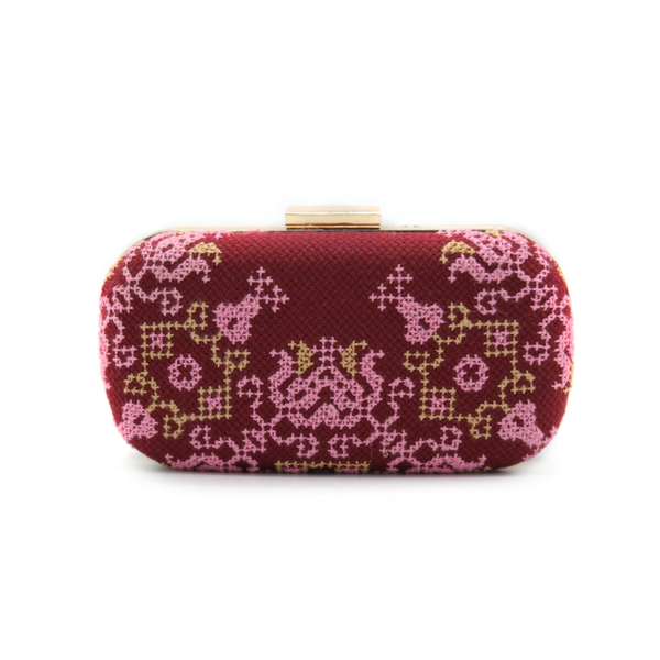 Handmade burgundy Tatreez evening clutch with pink and gold arabesque embroidery and gold clasp.