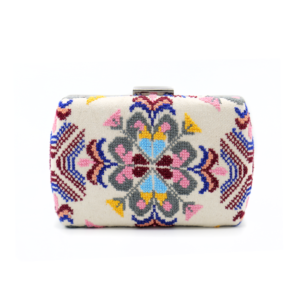 Symmetrical Palestinian Tatreez embroidered hardcase evening clutch bag with a silver metal clasp closure.