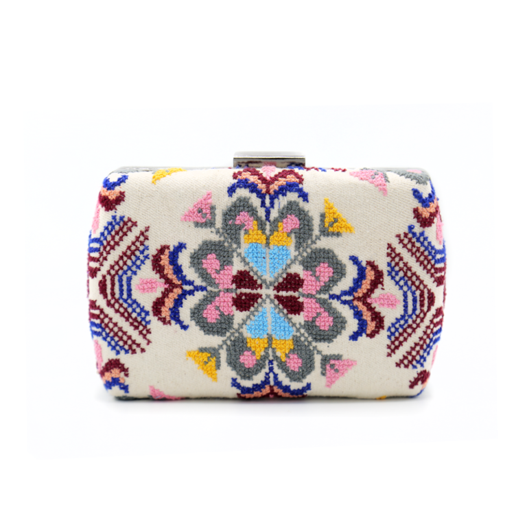 Symmetrical Palestinian Tatreez embroidered hardcase evening clutch bag with a silver metal clasp closure.