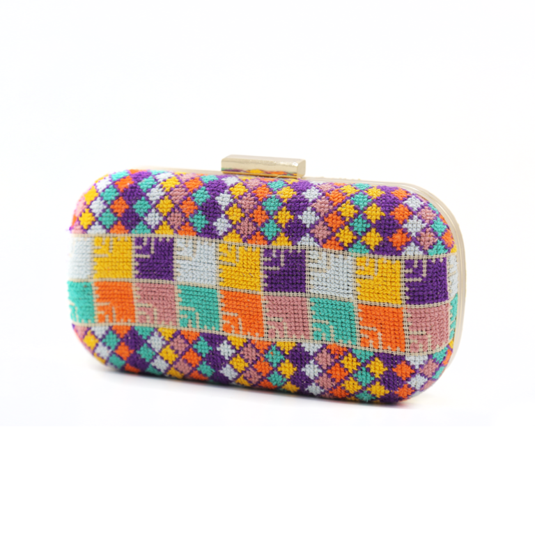 Handmade Palestinian Tatreez embroidered clutch purse featuring vibrant multi-colored geometric patterns and a gold clasp.
